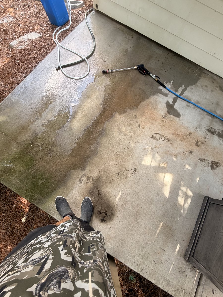 Ryan soft-washing a patio on the job