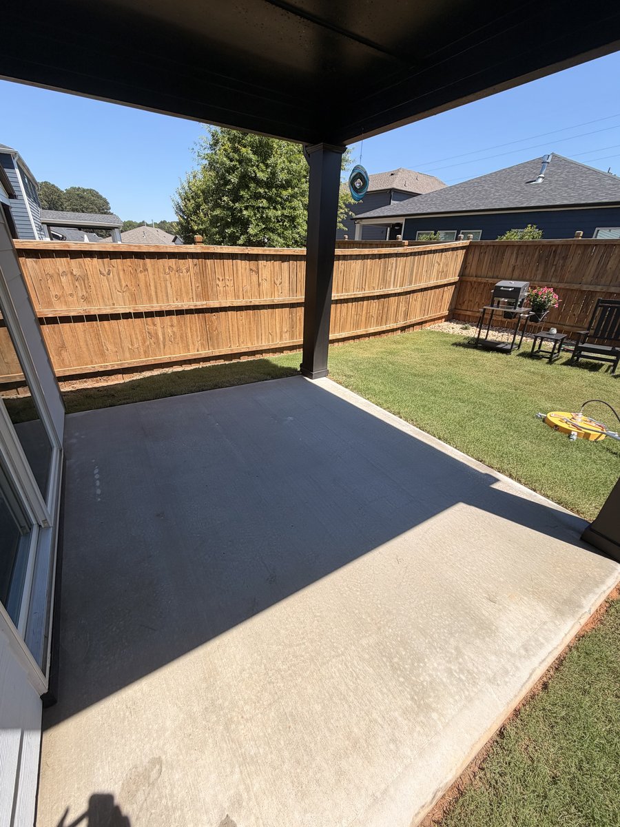 A freshly pressure-washed covered patio and clean concrete in a North Georgia backyard
